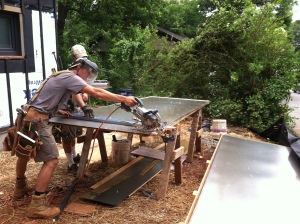using the abrasive blade to cut the steel siding panels