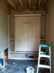 This is the murphy bed in the office surrounded by storage.