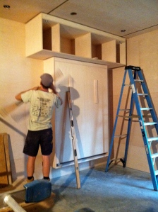 the first part of the sliding cabinet installed above the murphy bed
